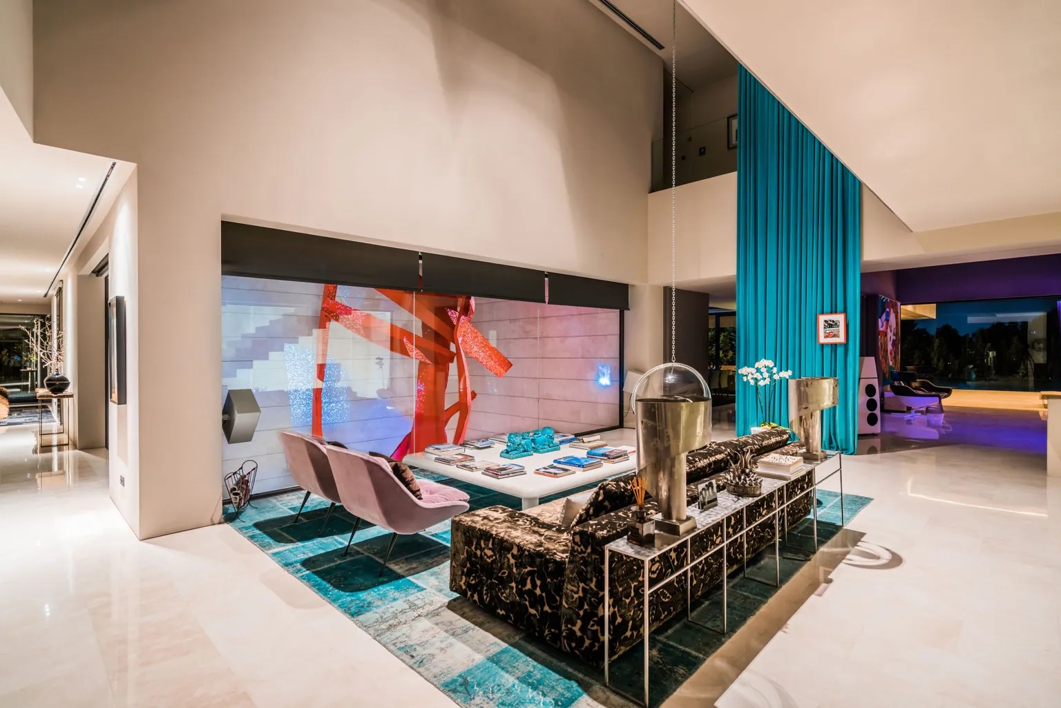 The double-height living room of a private villa at night